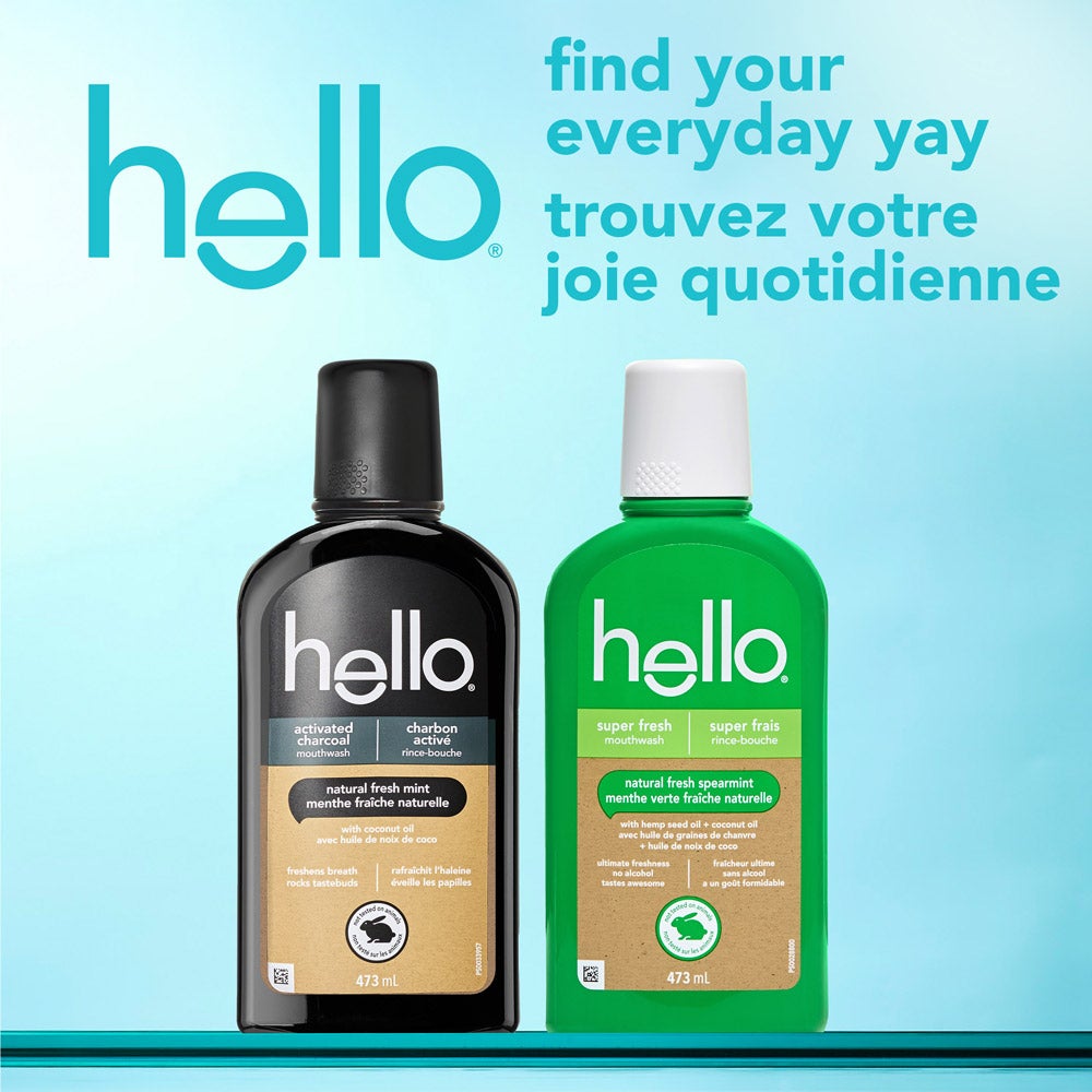 Two bottles of hello mouthwash standing side by side against a bright blue background. One bottle is black labeled "activated charcoal" and the other is green labeled "super fresh". The text above reads, "find your everyday yay" in English and the French translation below. The hello brand logo appears prominently at the top left.