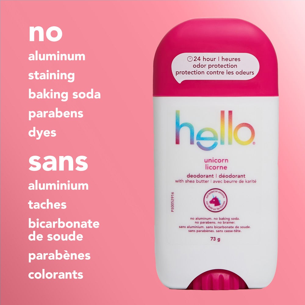 A close-up of a hello unicorn deodorant stick with a pink cap, standing upright on a pink background. The image features text listing product attributes: "no aluminum, staining, baking soda, parabens, dyes."